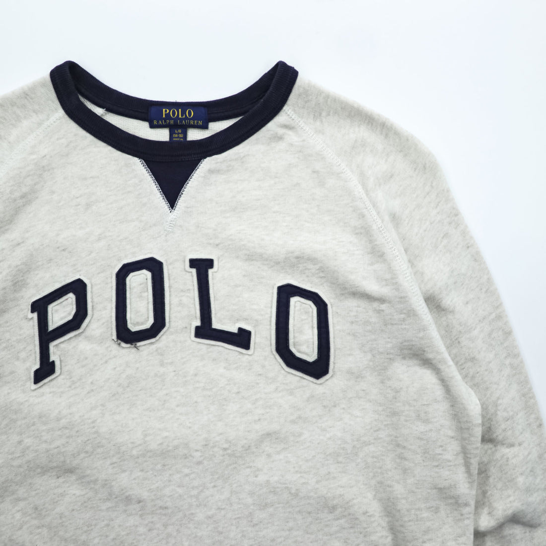 Polo Ralph Lauren V-gusset sweatshirt, size L, beige/navy, with arch logo patch and ribbed trim.