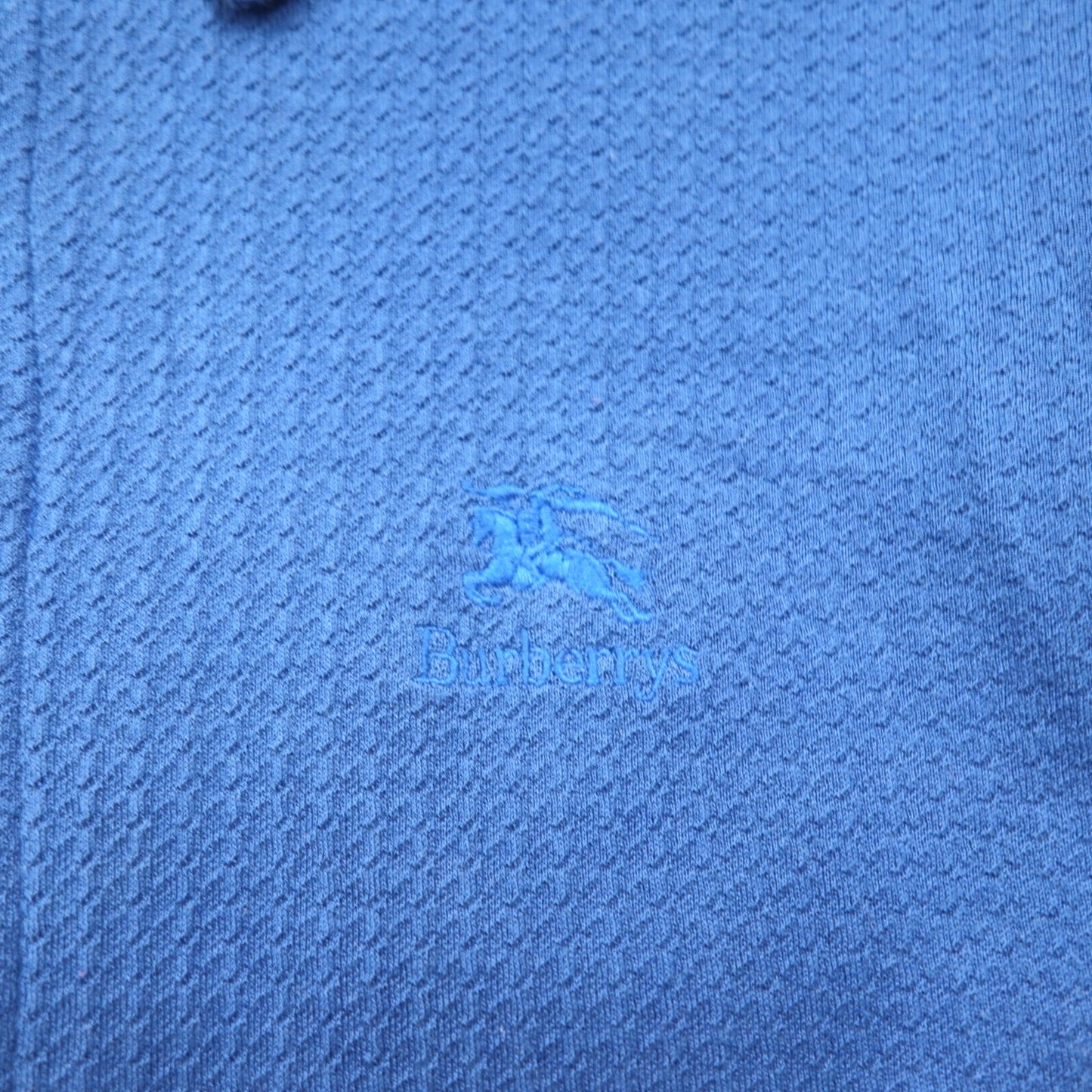 Burberry's USA-made jacquard polo shirt, size M, blue cotton, with one-point logo embroidery.